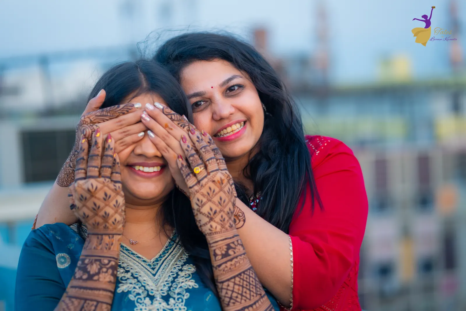 A friend playfully covering Priyanka’s eyes on the rooftop at her mehendi
