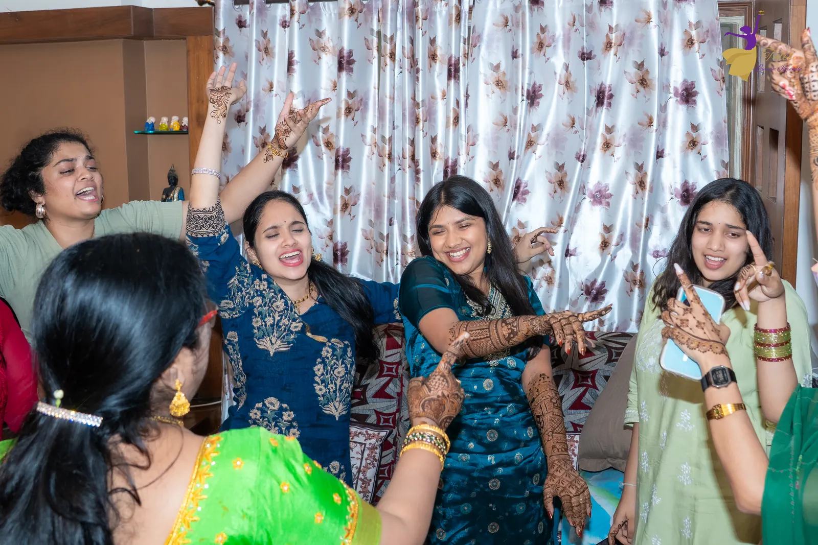 Priyanka dancing with cousins and friends, hands in the air, at her mehendi