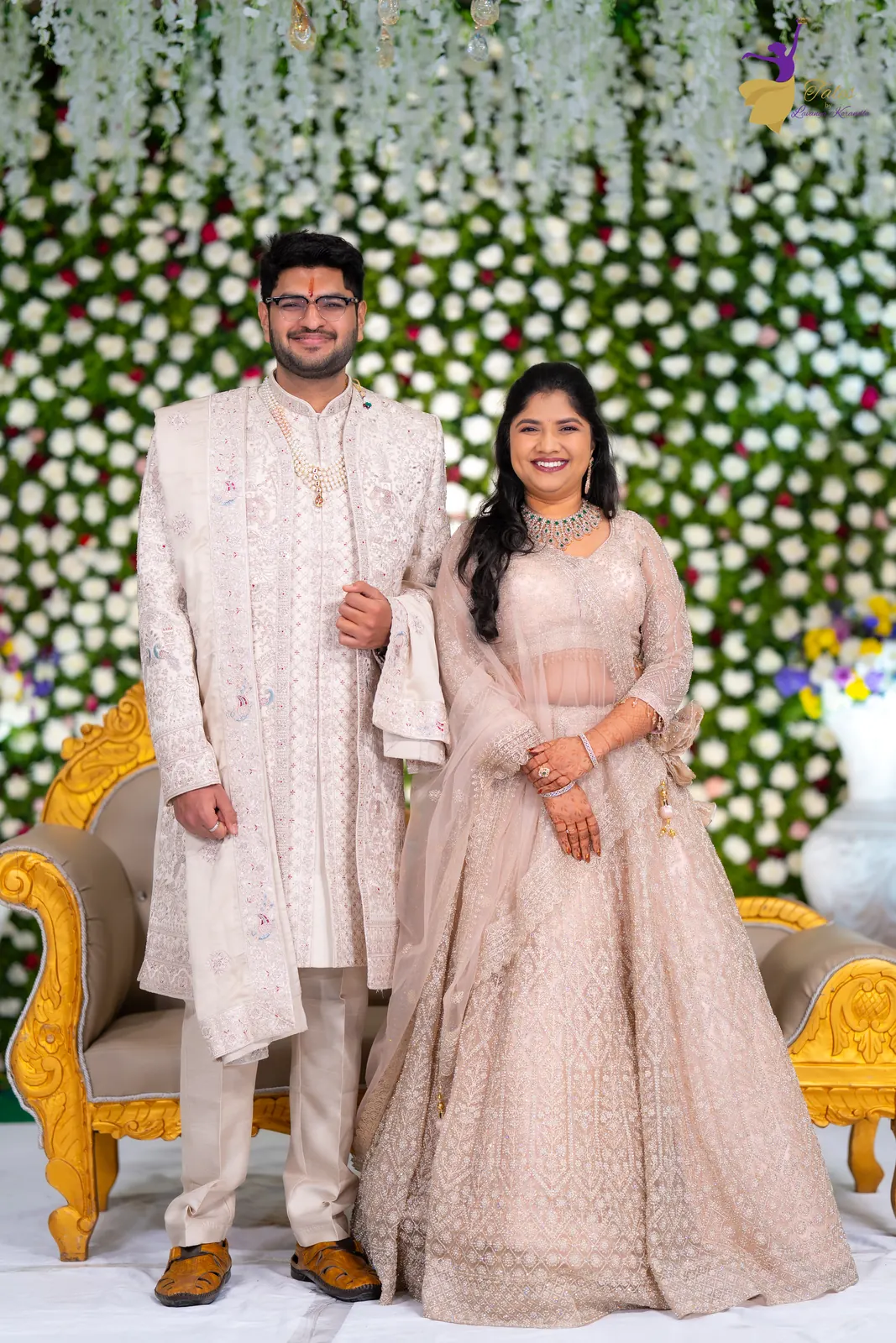 Aditya in an ivory sherwani and Priyanka in a blush lehenga on their reception stage