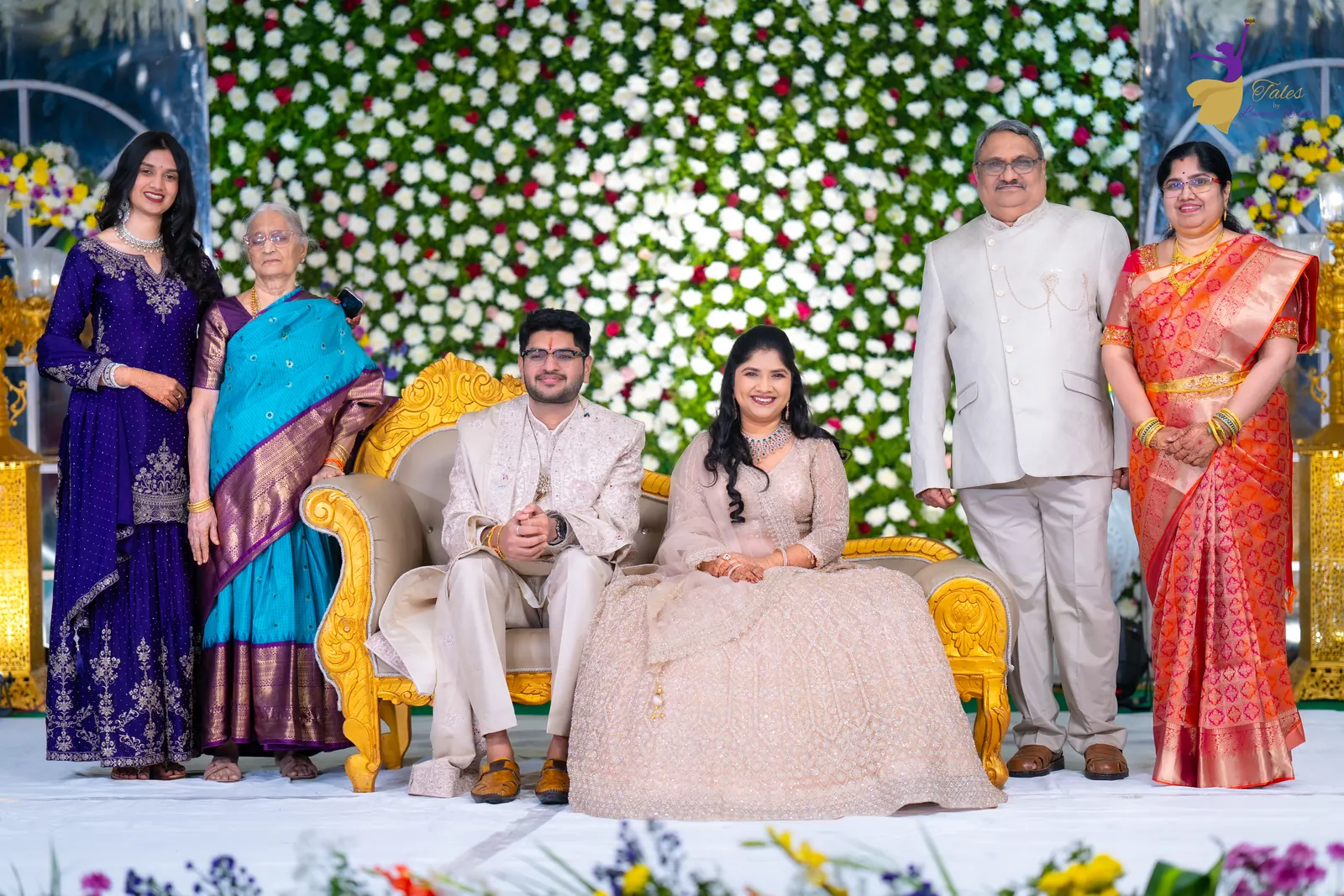 Aditya and Priyanka with family on the floral reception stage