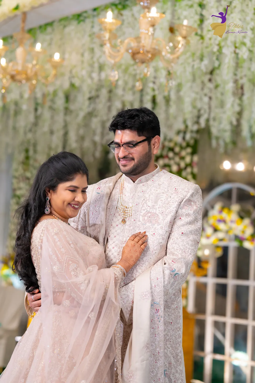 Priyanka leaning into Aditya and laughing at their wedding reception