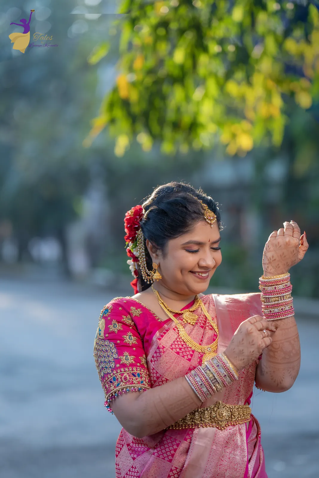 Priyanka laughing with her bangles raised under morning leaves