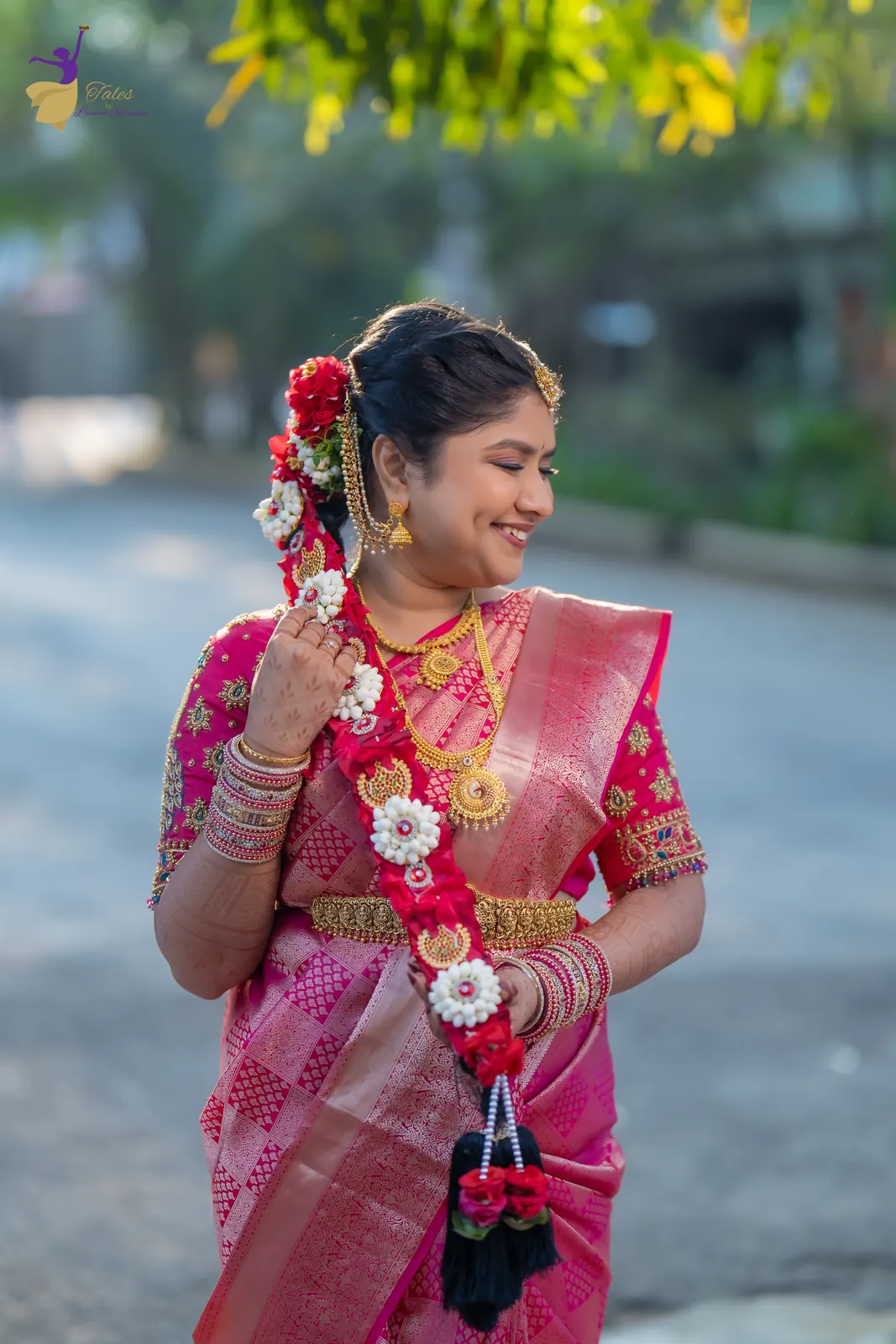 Priyanka holding a flower garland in golden morning light