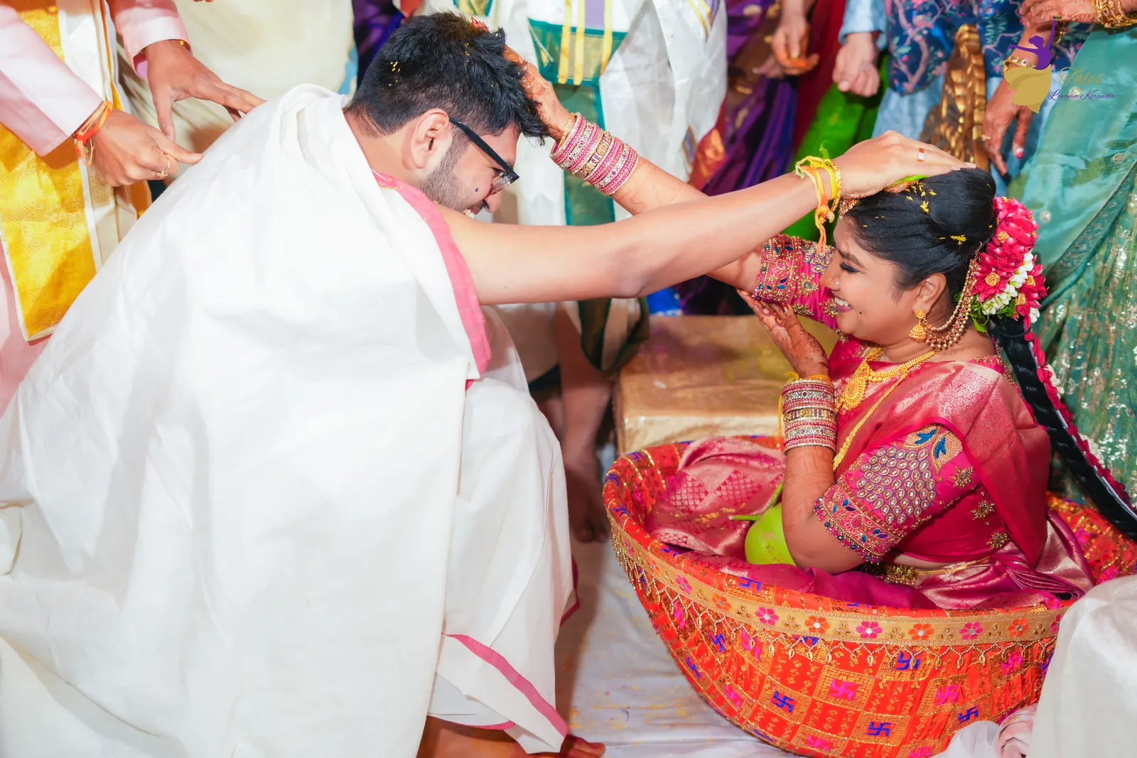 Jeelakarra bellam: Aditya and Priyanka placing hands on each other’s heads, Priyanka seated in the bamboo basket