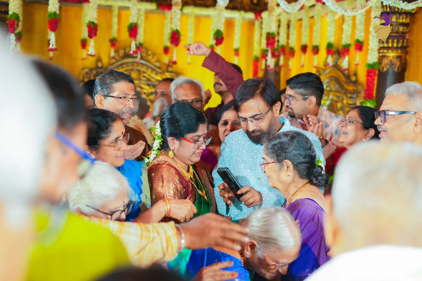 Family and guests crowding around the mandap during jeelakarra bellam