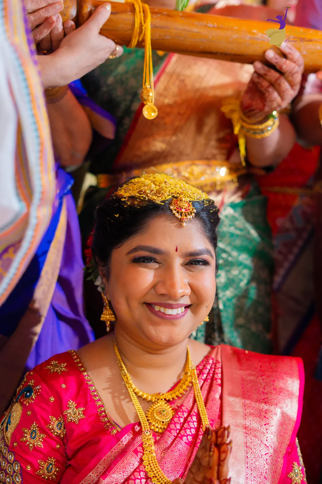 Close bridal portrait of Priyanka in bashikam, laughing at the mandap