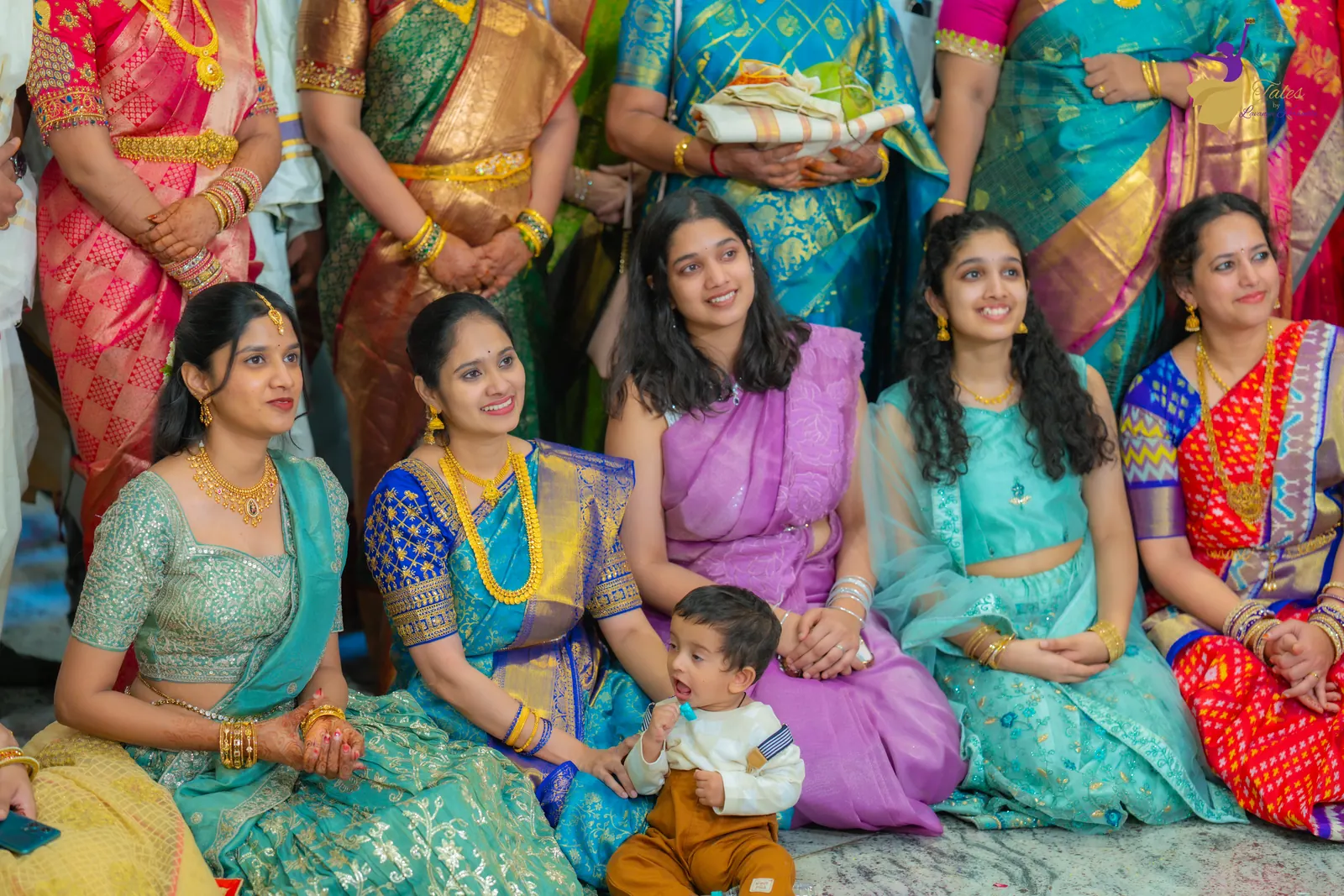 Cousins and family seated together, watching the wedding rituals