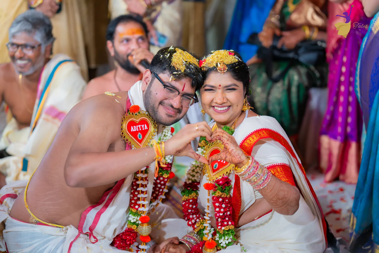 Aditya and Priyanka laughing in their garlands with cousins around them