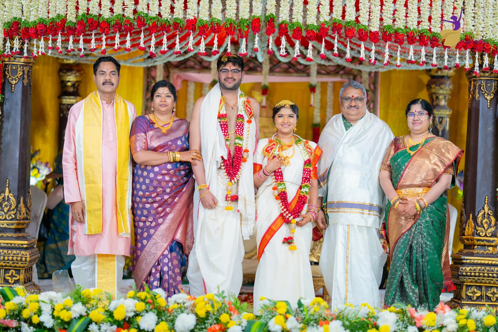 Aditya and Priyanka with their families on the mandap after the wedding