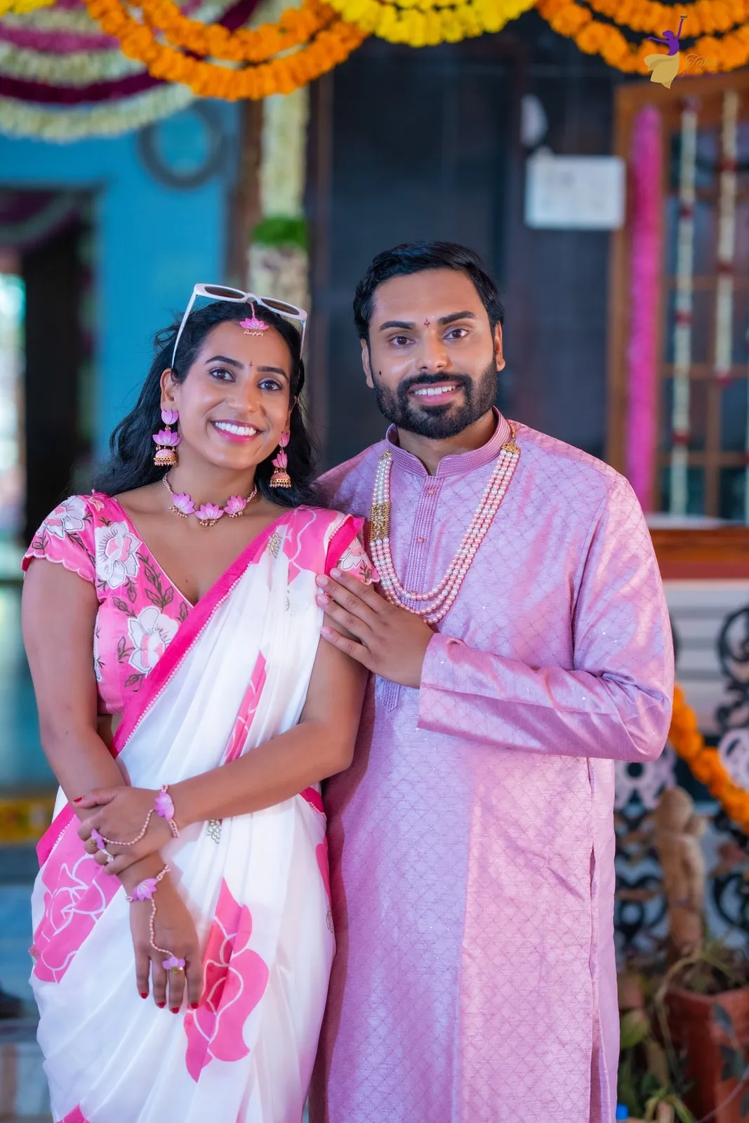 Manoj and Priya standing together at Haldi doorway, Amalapuram
