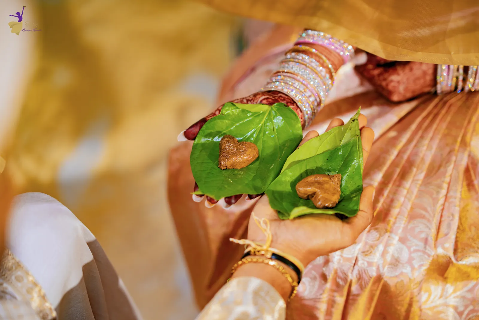 Mehendi hands holding betel leaves with jeelakarra bellam, Telugu wedding ritual