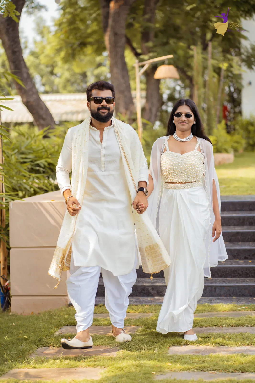Krishna and Vishwasa walking into their haldi together in white, both in sunglasses