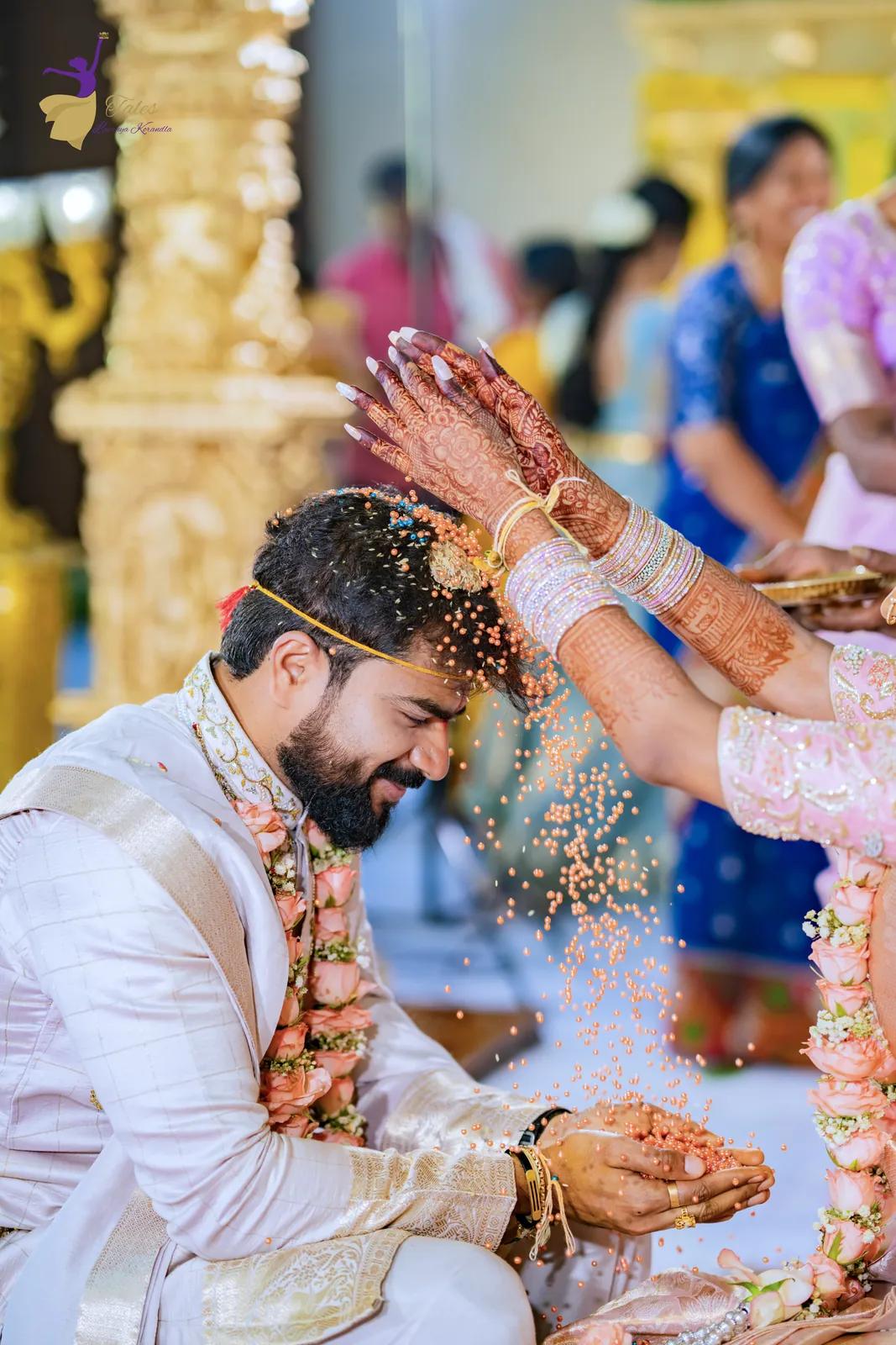Talambralu: the bride showering rice over the groom’s head