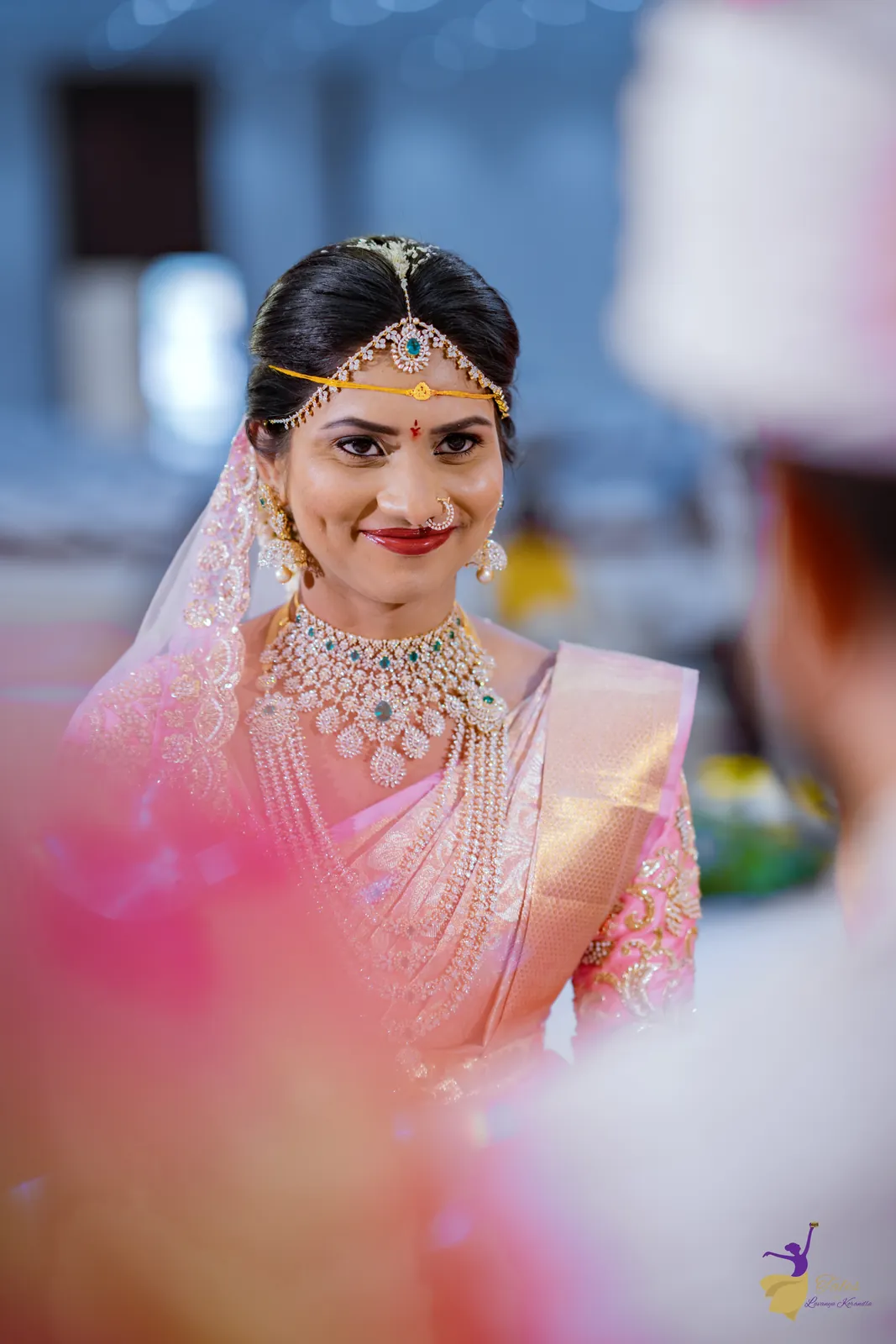 The bride smiling across the mandap during the wedding rituals