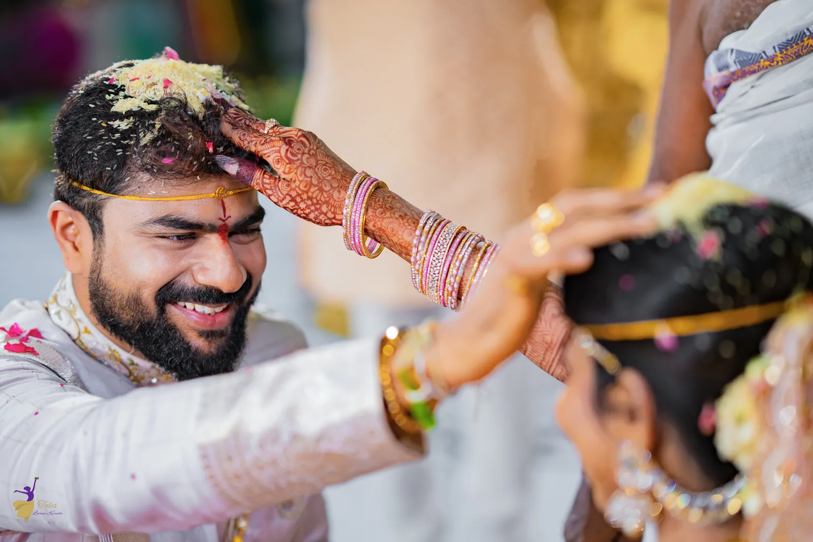 The bride placing jeelakarra bellam on the smiling groom’s head