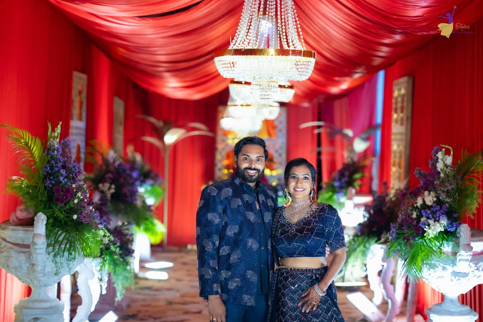 Warm pre-reception portrait of Manoj and Priya in navy blue