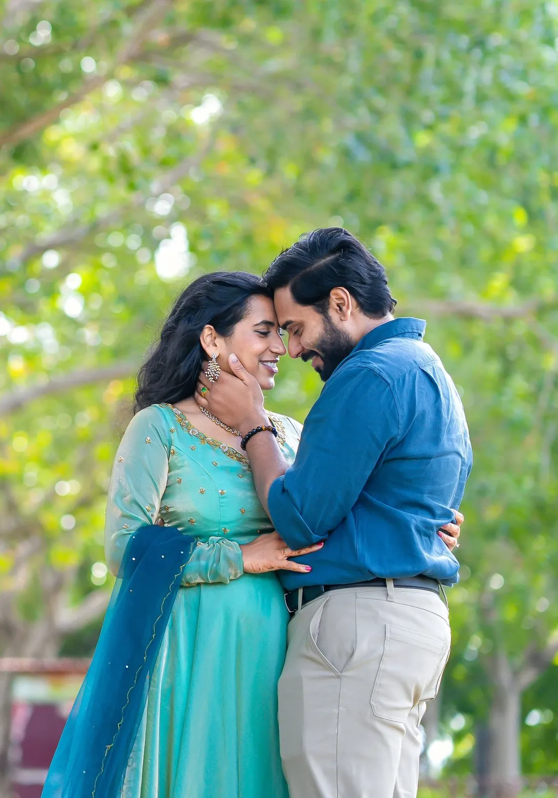 Couple looking at each other in dappled park light, Hyderabad pre-wedding