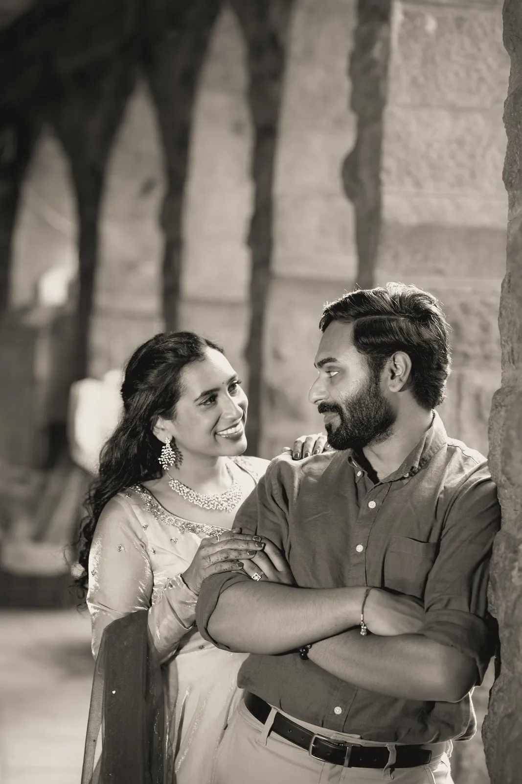 Sepia portrait of Manoj and Priya in a stone corridor, pre-wedding