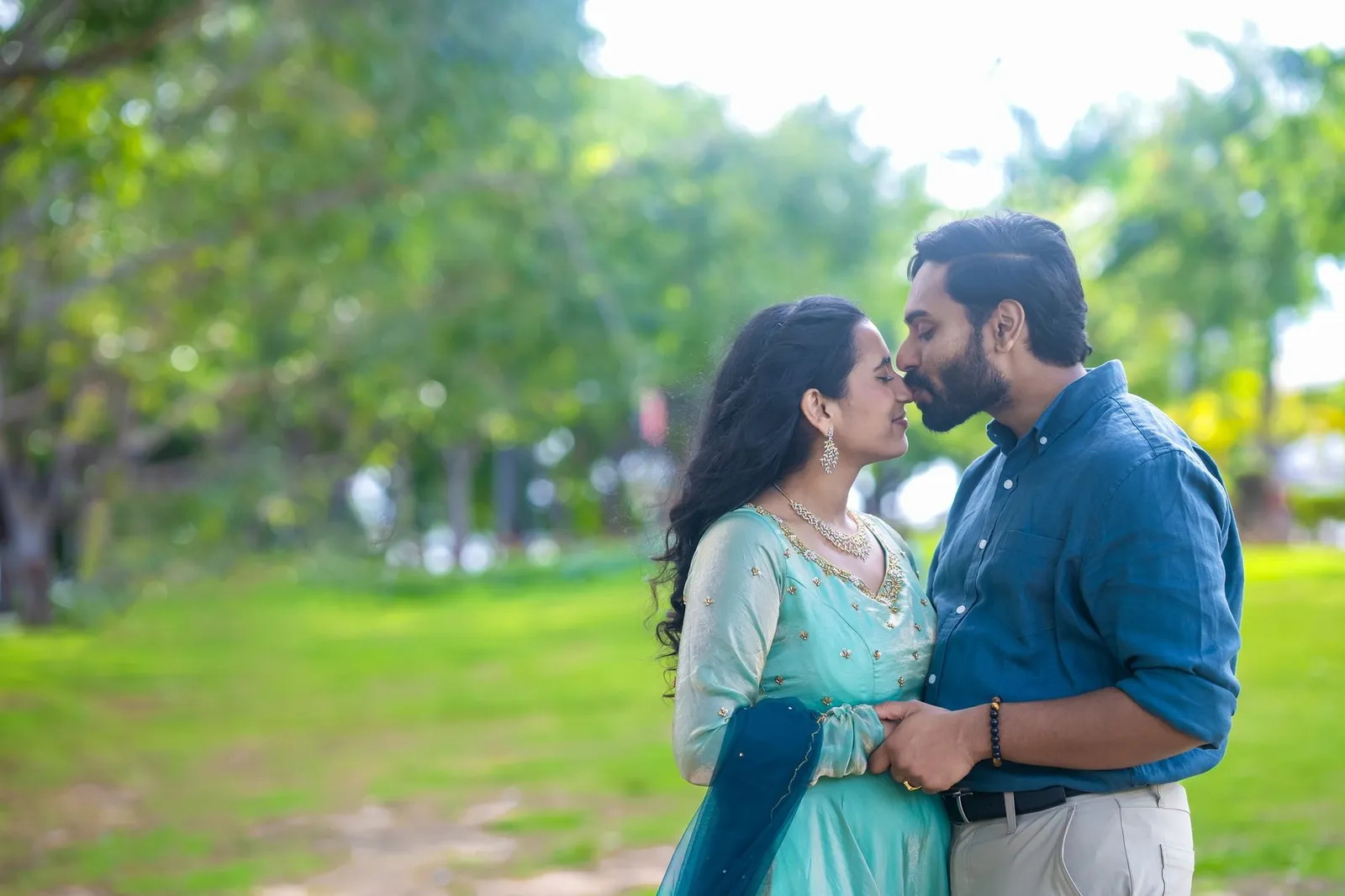 Manoj and Priya smiling in a green park, Hyderabad pre-wedding shoot