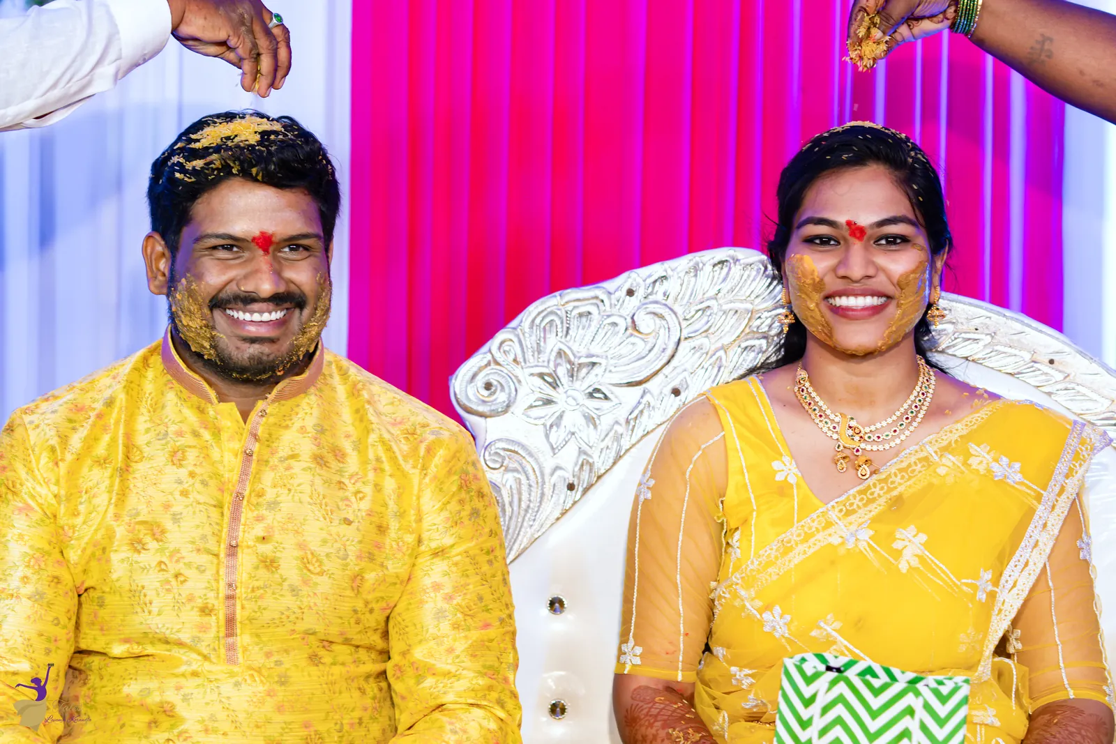 Ravinder and Anuhya in yellow with red tilak, beaming at the end of their haldi