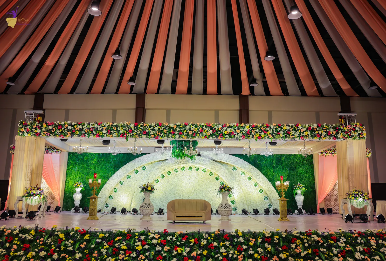 Wide view of the grand reception hall and floral stage before the guests arrive