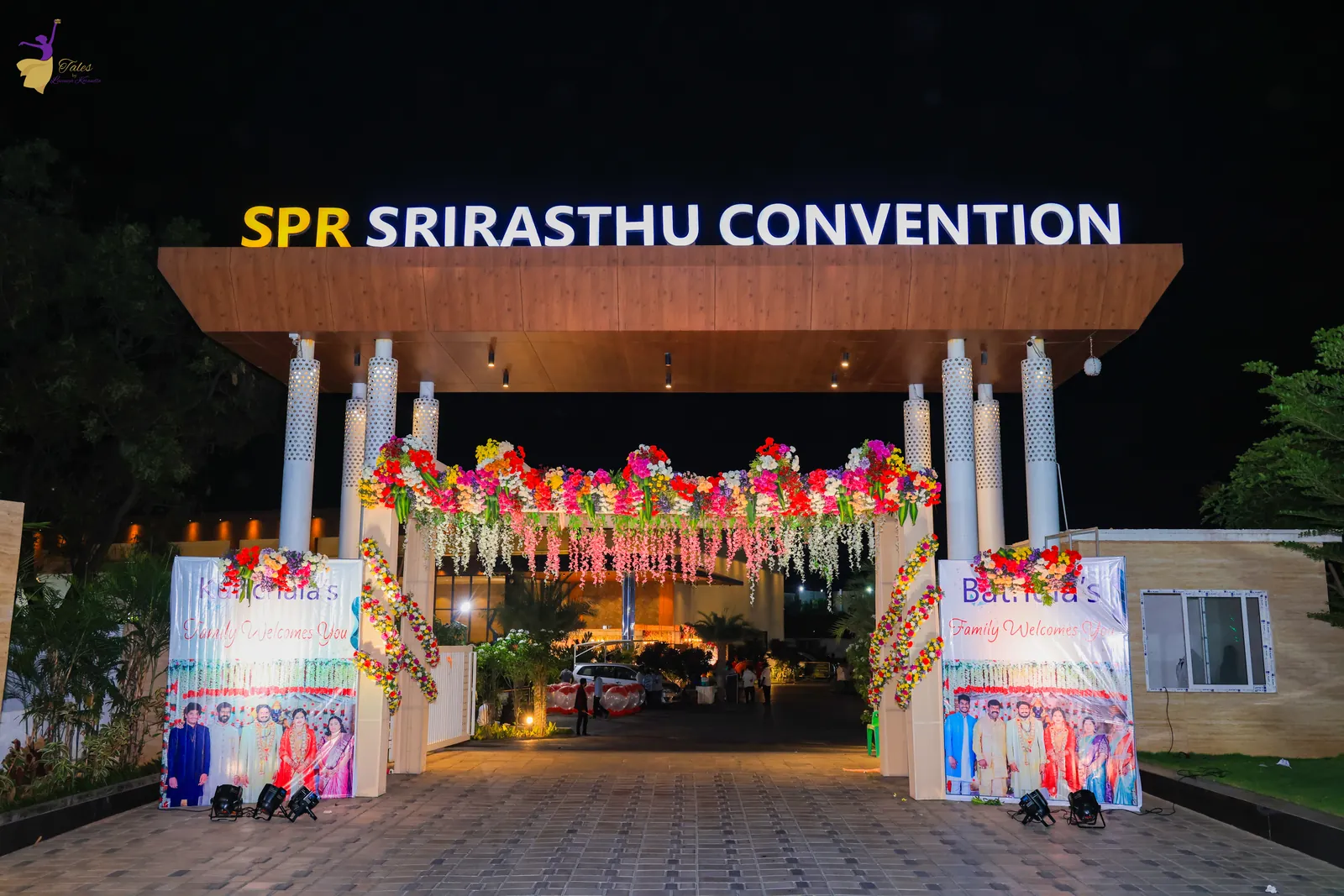 The reception venue entrance lit up at night with flower decor, Hyderabad