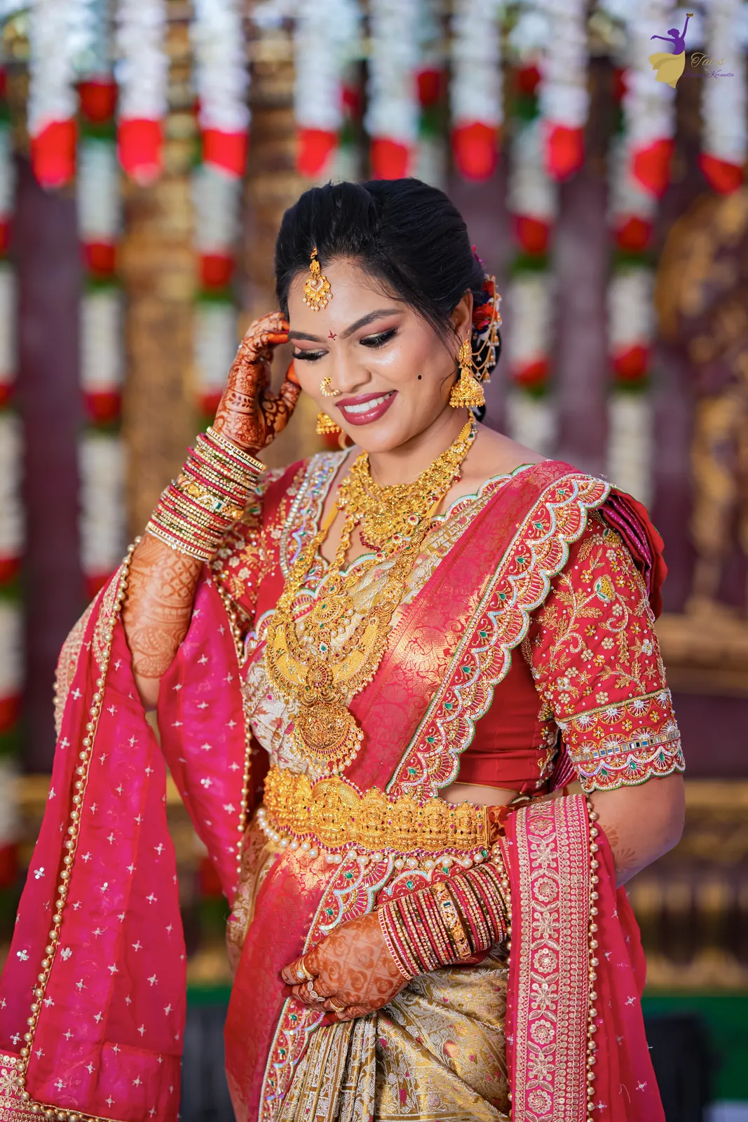 Bridal portrait of Anuhya in a red and gold silk saree with temple jewellery, Hyderabad wedding