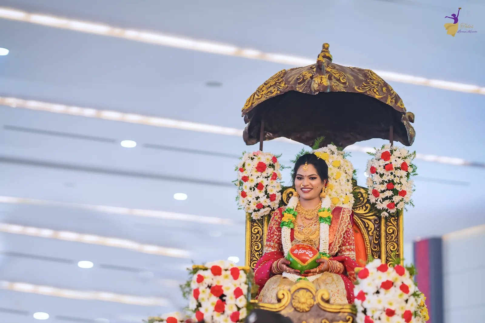 Bride Anuhya’s entry seated in a flower-decked palanquin under a golden umbrella