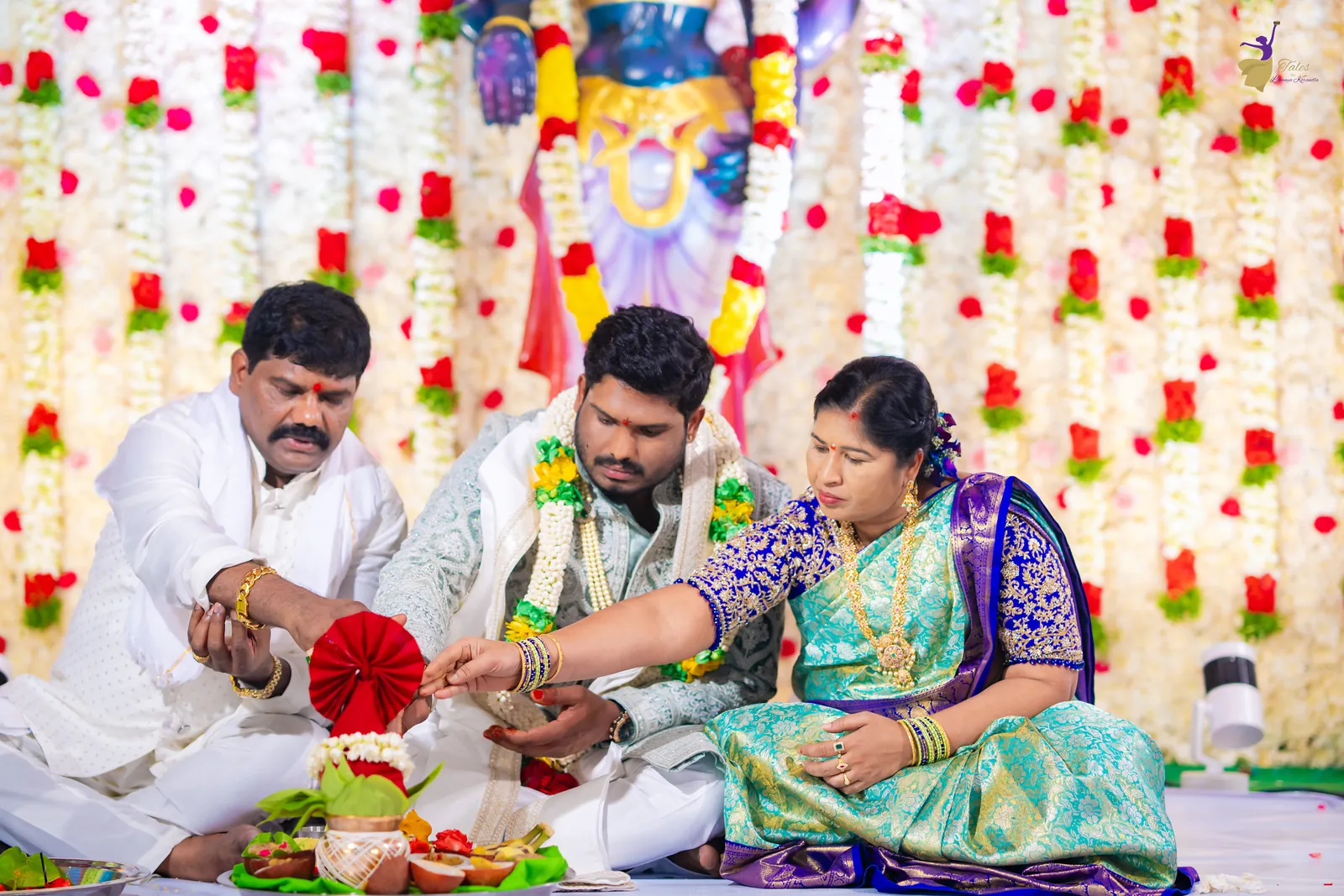 Ravinder seated with family for the opening wedding puja at the mandap