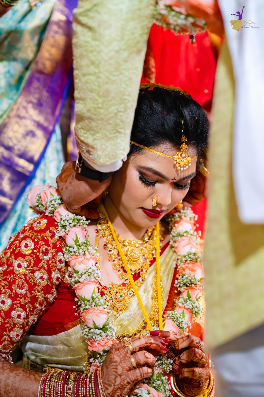 Anuhya looking down at her thali (mangalsutra) moments after it is tied