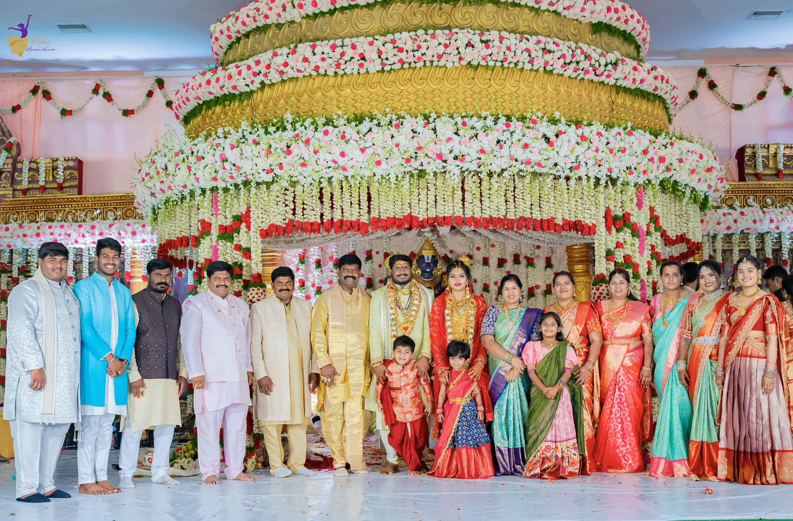 Wide shot of the grand tiered floral mandap with the couple and their families, Hyderabad wedding
