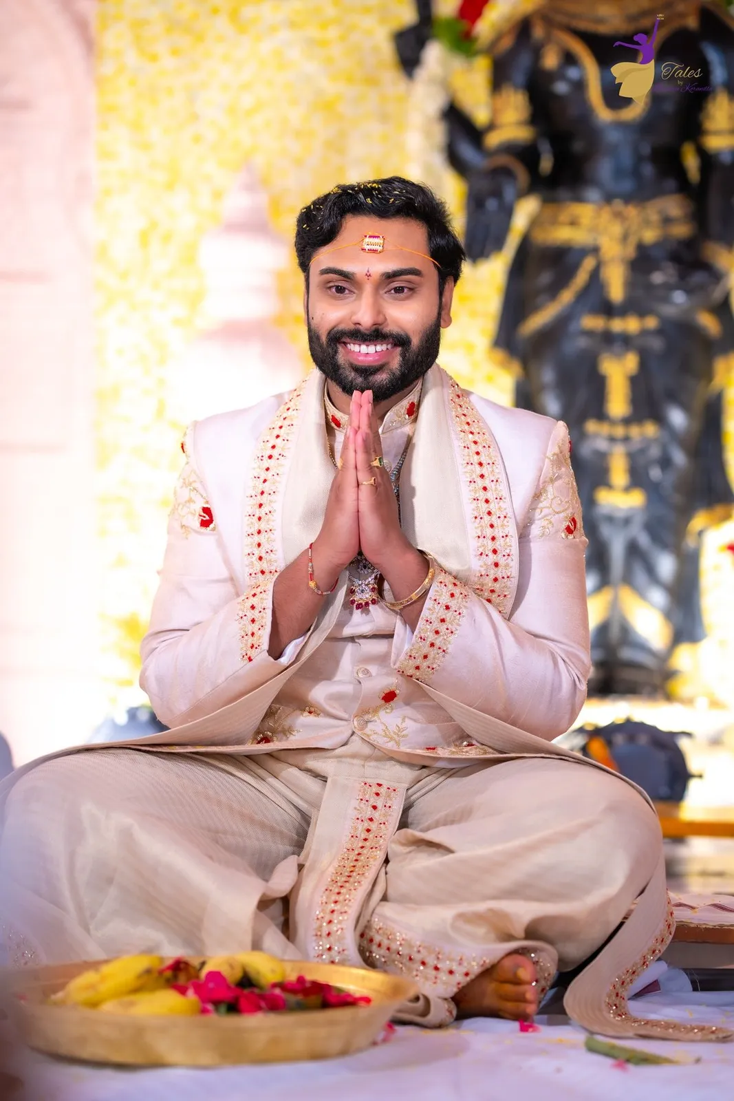 Manoj seated in namaste during wedding prayers, Amalapuram