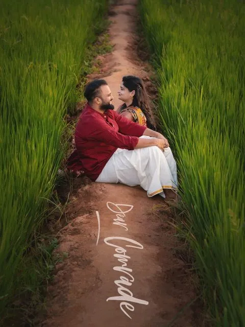 Couple seated on a path between green paddy fields, Hyderabad couple photoshoot