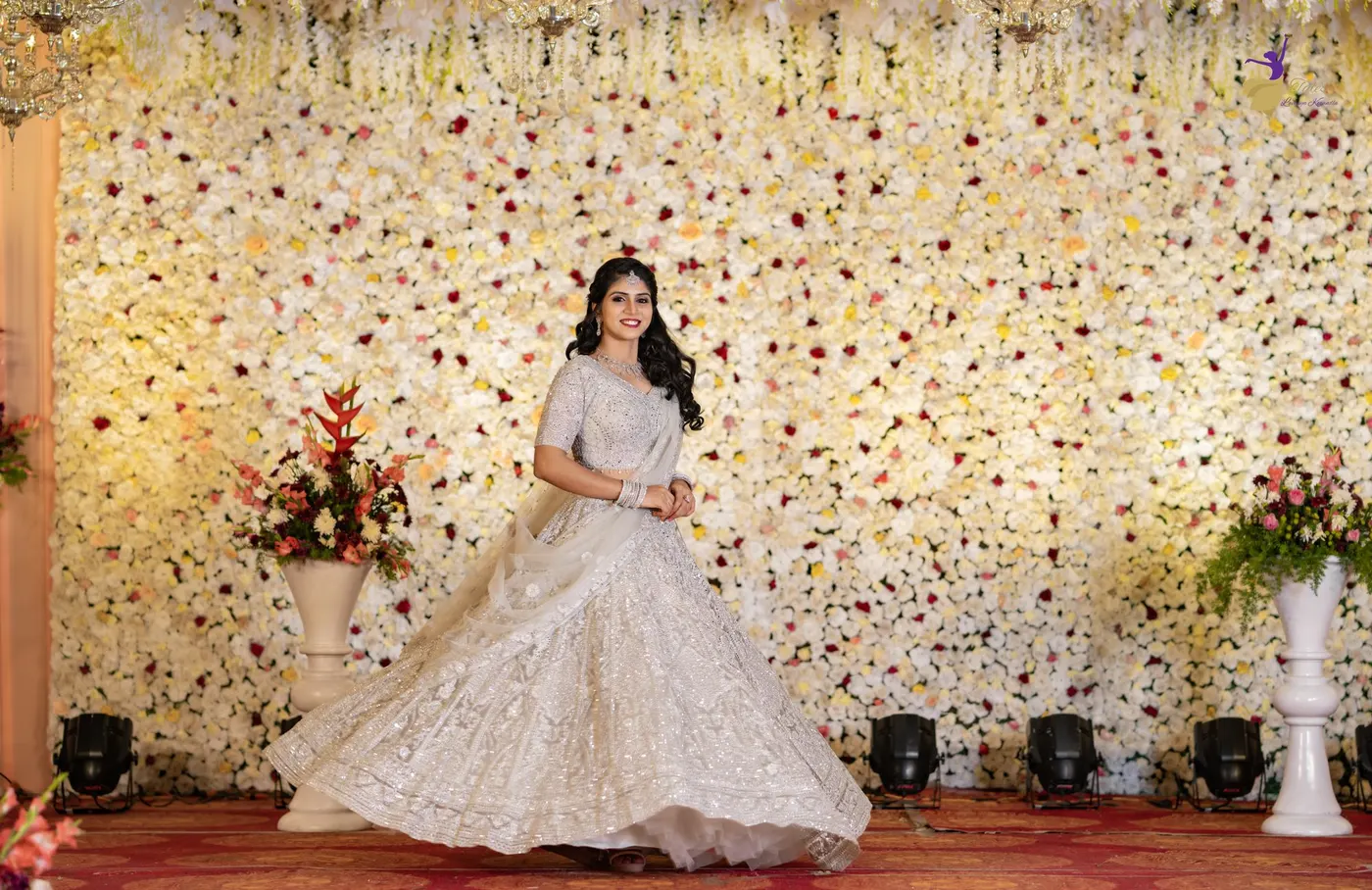 Bride before a wall of white flowers, Hyderabad wedding