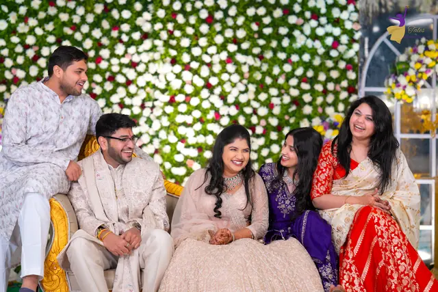 Aditya and Priyanka laughing on the reception sofa with their cousins