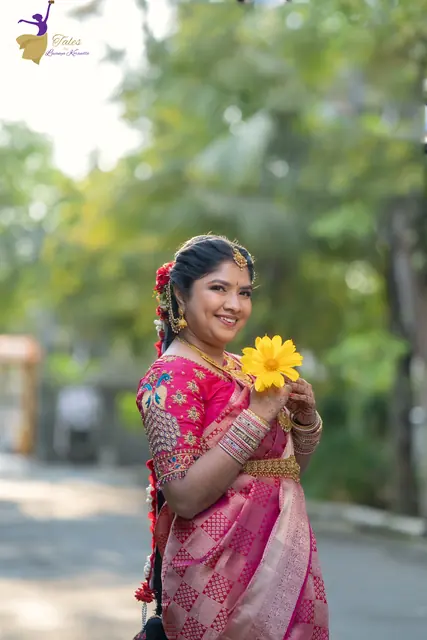 Priyanka holding a yellow flower on a tree-lined road at sunrise
