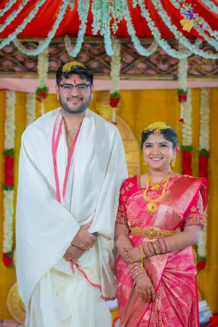 Aditya and Priyanka smiling at the flower-decked mandap, Telugu wedding