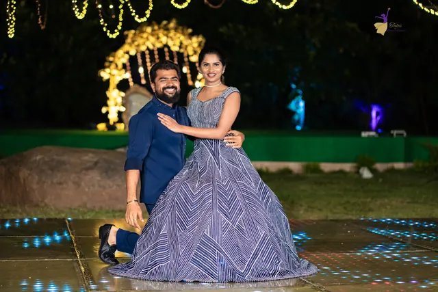 Groom in navy hugging the bride in a lavender lehenga on a lit dance floor