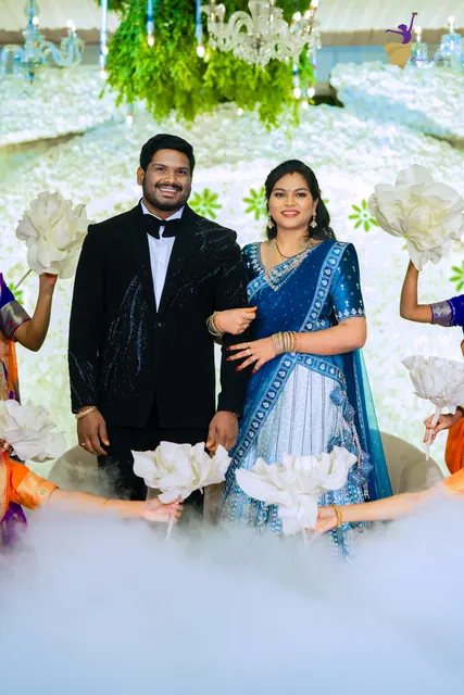 Ravinder and Anuhya making their reception entry through white fog and flowers