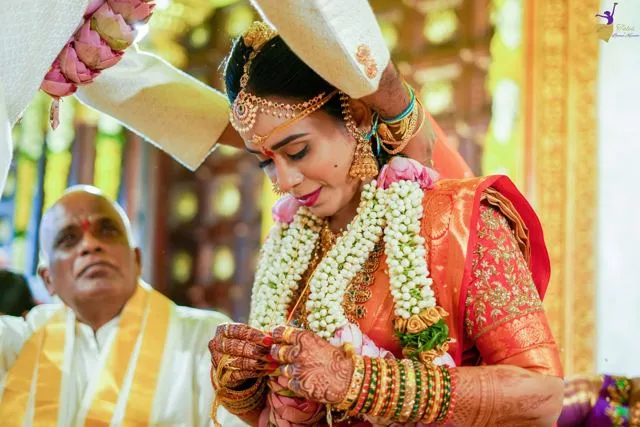 Wedding ritual with priest as groom blesses the bride, Hyderabad
