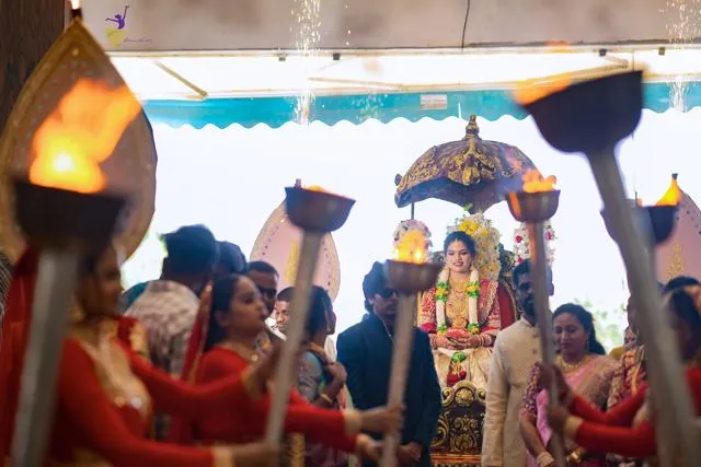 Ceremony framed by traditional torches, Telugu wedding