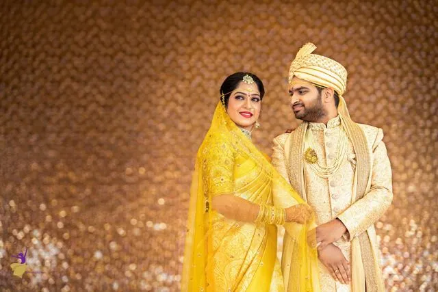 Bride in yellow silk saree and groom in cream sherwani, Telugu wedding portrait, Hyderabad