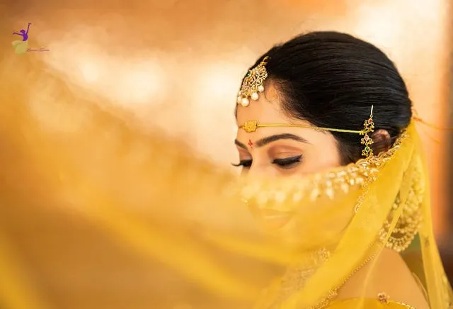 Bridal close-up with sheer yellow veil and maang tikka, Telugu wedding